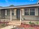 Covered front porch showcasing decorative brickwork, white columns, and a secure, steel entry door at 2805 Grassmere Ln, Orlando, FL 32808