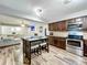 A stunning kitchen featuring stainless steel appliances and a dark wood center island with seating at 2805 Grassmere Ln, Orlando, FL 32808