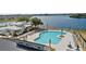 Aerial view showcasing a community pool, clubhouse, and lakefront properties in a scenic setting at 2977 Howley Aly, St Cloud, FL 34771