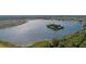 Aerial view of a tranquil lake with an island surrounded by residential communities at 2977 Howley Aly, St Cloud, FL 34771