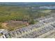 Expansive aerial view of new construction homes with an adjacent large wooded parcel at 2977 Howley Aly, St Cloud, FL 34771