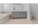 Bathroom featuring double sinks and a large soaking tub at 2977 Howley Aly, St Cloud, FL 34771