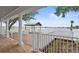 Community deck with a covered seating area overlooking the tranquil lake at 2977 Howley Aly, St Cloud, FL 34771