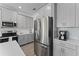 Modern kitchen with stainless steel refrigerator and gray cabinets, countertop coffee maker at 2977 Howley Aly, St Cloud, FL 34771