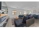 Open concept living room with a gray sectional, adjacent to the kitchen and dining area at 2977 Howley Aly, St Cloud, FL 34771