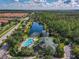 Expansive aerial view featuring a community pool, the clubhouse, and a stunning lake at 3050 Pirates Retreat Ct # 207, Kissimmee, FL 34747