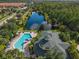 Stunning aerial view of community amenities featuring inviting pool, clubhouse, lake, and well-kept grounds at 3050 Pirates Retreat Ct # 207, Kissimmee, FL 34747