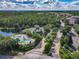 Aerial photograph highlighting the community entrance, pool area, clubhouse, and scenic lake views at 3050 Pirates Retreat Ct # 207, Kissimmee, FL 34747