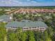 Expansive aerial view of community showcasing lush landscaping, red tile roofs, and well-maintained buildings at 3050 Pirates Retreat Ct # 207, Kissimmee, FL 34747