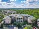 Aerial view of Caribe Cove condos surrounded by lush green trees and foliage at 3050 Pirates Retreat Ct # 207, Kissimmee, FL 34747