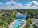 A captivating aerial view of a lake and pool offering an oasis of relaxation and recreation at 3050 Pirates Retreat Ct # 207, Kissimmee, FL 34747