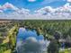 Scenic aerial view of lake surrounded by trees, offering serene backdrop for community living at 3050 Pirates Retreat Ct # 207, Kissimmee, FL 34747