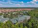 Beautiful aerial view of lushly landscaped community, showcasing pond, residences, and the surrounding area at 3050 Pirates Retreat Ct # 207, Kissimmee, FL 34747