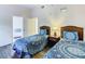 Comfortable bedroom showcases twin beds, wood furniture, and neutral walls at 3050 Pirates Retreat Ct # 207, Kissimmee, FL 34747