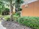 Exterior view of a building entrance at Caribe Cove, surrounded by lush green landscaping at 3050 Pirates Retreat Ct # 207, Kissimmee, FL 34747