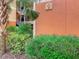 View of a building entrance at Caribe Cove with lush green landscaping and a sign indicating building 2 at 3050 Pirates Retreat Ct # 207, Kissimmee, FL 34747