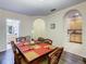 Dining room featuring a wood table with ornate chairs with view into the kitchen and bathroom areas at 3050 Pirates Retreat Ct # 207, Kissimmee, FL 34747