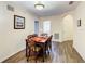 Relaxing dining room featuring a wood table and chairs with views into the bathroom and kitchen areas at 3050 Pirates Retreat Ct # 207, Kissimmee, FL 34747