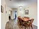 Dining room featuring a wood table and chairs with views into the hallway and living areas at 3050 Pirates Retreat Ct # 207, Kissimmee, FL 34747