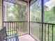 Serene screened-in porch showcases peaceful views of the surrounding nature at 3050 Pirates Retreat Ct # 207, Kissimmee, FL 34747