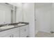 Modern bathroom with double vanity, granite countertop and a glass-enclosed shower at 3189 Viceroy Ct, Poinciana, FL 34759