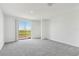 Bright, carpeted bedroom with sliding glass door, offering plenty of natural light and outdoor views at 3189 Viceroy Ct, Poinciana, FL 34759