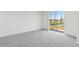 Bright, carpeted bedroom features a sliding glass door with scenic views of a pond at 3189 Viceroy Ct, Poinciana, FL 34759