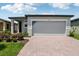 Charming single-story home featuring a two-car garage, lovely landscaping, and a welcoming brick driveway at 3189 Viceroy Ct, Poinciana, FL 34759