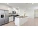 Bright kitchen features an island, stainless steel refrigerator, and tile floors at 3189 Viceroy Ct, Poinciana, FL 34759