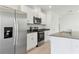 Bright kitchen features stainless steel refrigerator and granite countertops at 3189 Viceroy Ct, Poinciana, FL 34759