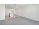 Open-concept living space with carpeted flooring, kitchen area, and abundant natural light at 3189 Viceroy Ct, Poinciana, FL 34759