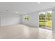 Bright living room with tile flooring and sliding doors to outdoor space at 3190 Viceroy Ct, Poinciana, FL 34759