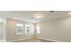 Bright bedroom with three windows, neutral walls, and wood-look flooring at 360 Birkdale Dr, Daytona Beach, FL 32124