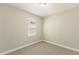 Small bedroom with a window and neutral carpet at 360 Birkdale Dr, Daytona Beach, FL 32124