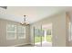 Bright dining room features sliding glass doors, wood floor, and decorative chandelier at 360 Birkdale Dr, Daytona Beach, FL 32124