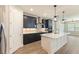 Stylish kitchen featuring stainless steel appliances, a center island, modern pendant lights, and dark blue cabinets at 360 Birkdale Dr, Daytona Beach, FL 32124