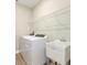 Laundry room includes washer, dryer, sink, and wire shelving at 360 Birkdale Dr, Daytona Beach, FL 32124