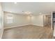 Spacious living area featuring wood-look flooring and ample natural light from a large window at 360 Birkdale Dr, Daytona Beach, FL 32124