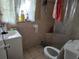 Modest bathroom with tiled walls, a shower with curtains and an updated toilet and sink at 39 N Oxalis Dr, Orlando, FL 32807