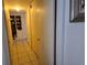 Hallway with tile flooring, multiple closets, and an ornate framed picture on the wall at 39 N Oxalis Dr, Orlando, FL 32807