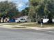 Street view of a cozy home featuring mature trees and convenient parking at 4005 Clarcona Ocoee Rd, Orlando, FL 32810