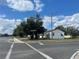 Street view of a white home with mature landscaping on a sunny day at 4005 Clarcona Ocoee Rd, Orlando, FL 32810