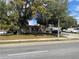 Neighborhood street view of well-maintained homes with mature trees and lush landscaping at 4007 Clarcona Ocoee Rd, Orlando, FL 32810