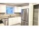 Modern kitchen featuring white cabinets, stainless steel appliances, and granite countertops at 4164 Plantation Village Condos Dr # 504, Orlando, FL 32810