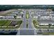 An aerial view of a new construction neighborhood with tree-lined streets and a playground at 4307 Campsite Loop, Orlando, FL 32824