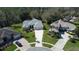 An aerial view of several homes with beautiful lawns and landscaping, with mature trees surrounding the properties at 4532 Saddleworth Cir, Orlando, FL 32826