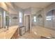 Bathroom with a soaking tub, large mirror, and dual sinks at 4532 Saddleworth Cir, Orlando, FL 32826