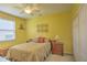 Bedroom with yellow walls and a ceiling fan at 4532 Saddleworth Cir, Orlando, FL 32826