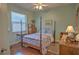 Bedroom with a four-poster bed and wooden floors at 4532 Saddleworth Cir, Orlando, FL 32826