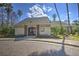 Community clubhouse featuring a brick entryway, light siding and mature landscaping at 4532 Saddleworth Cir, Orlando, FL 32826